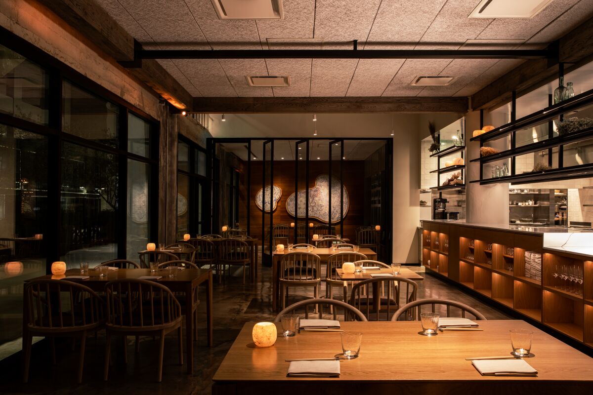 A moody photo of the dining room of Kato restaurant.