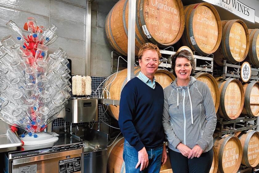 Owners Lowell and Anne Jooste stand between their barrels of craft wine and their growlers, ready to fill at LJ Crafted Wines, which is open 4-10 p.m. Monday-Thursday; 1-11 p.m. Friday-Saturday; and 2-8 p.m. Sunday at 5621 La Jolla Blvd., La Jolla. (858) 551-8890. ljcraftedwines.com