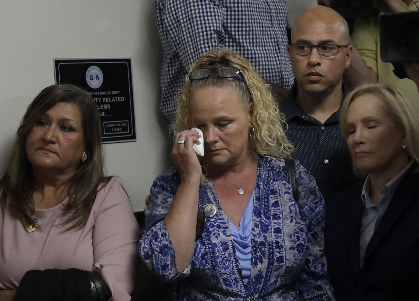 Kimberly and David Gregory, center and top right, the parents of Michela Gregory, a victim of the 2016 Ghost Ship warehouse fire, sit next to attorney Mary Alexander, right, during a news conference at a courthouse in Oakland.