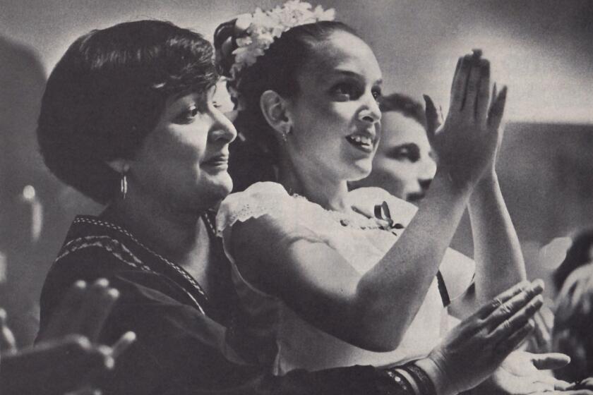 Barbara Brown and daughter Samantha attend a Mexican dance. Such events help Latinos to hold on to their cultural traditions.