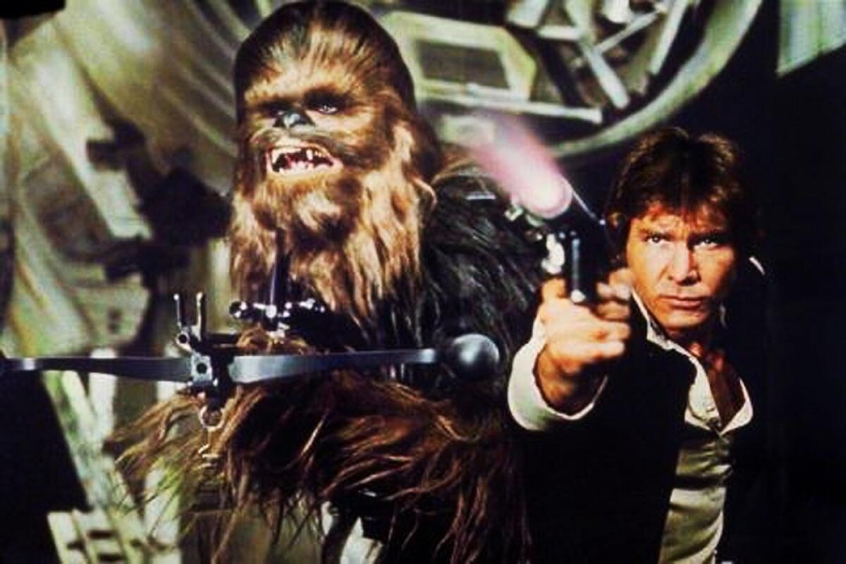 Peter Mayhew as Chewbacca, left, and Harrison Ford as Han Solo in an image from the first "Star Wars" movie