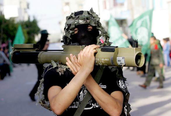 A Palestinian militant of the Islamist group Hamas carries a light anti-tank weapon of the Israeli army during a parade in the Bureij refugee camp in central Gaza Strip.