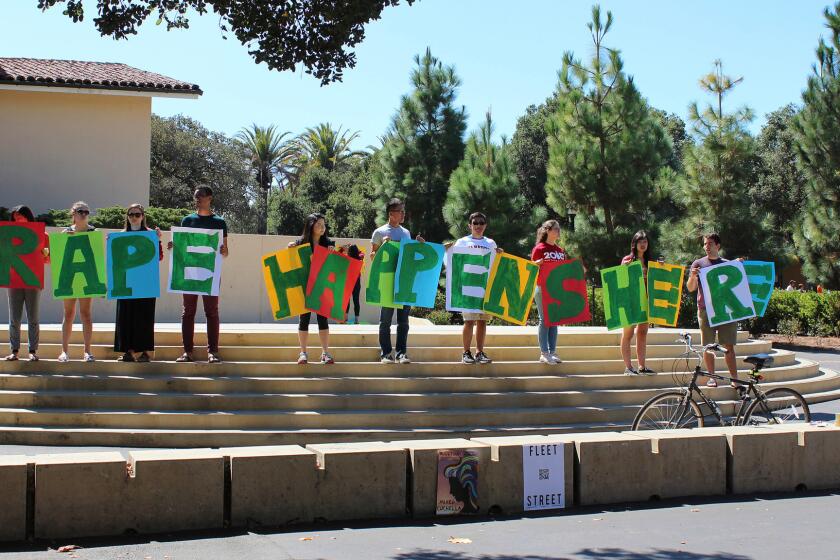 Students hold up a sign about rape at White Plaza during New Student Orientation on the Stanford University campus in Stanford, Calif.