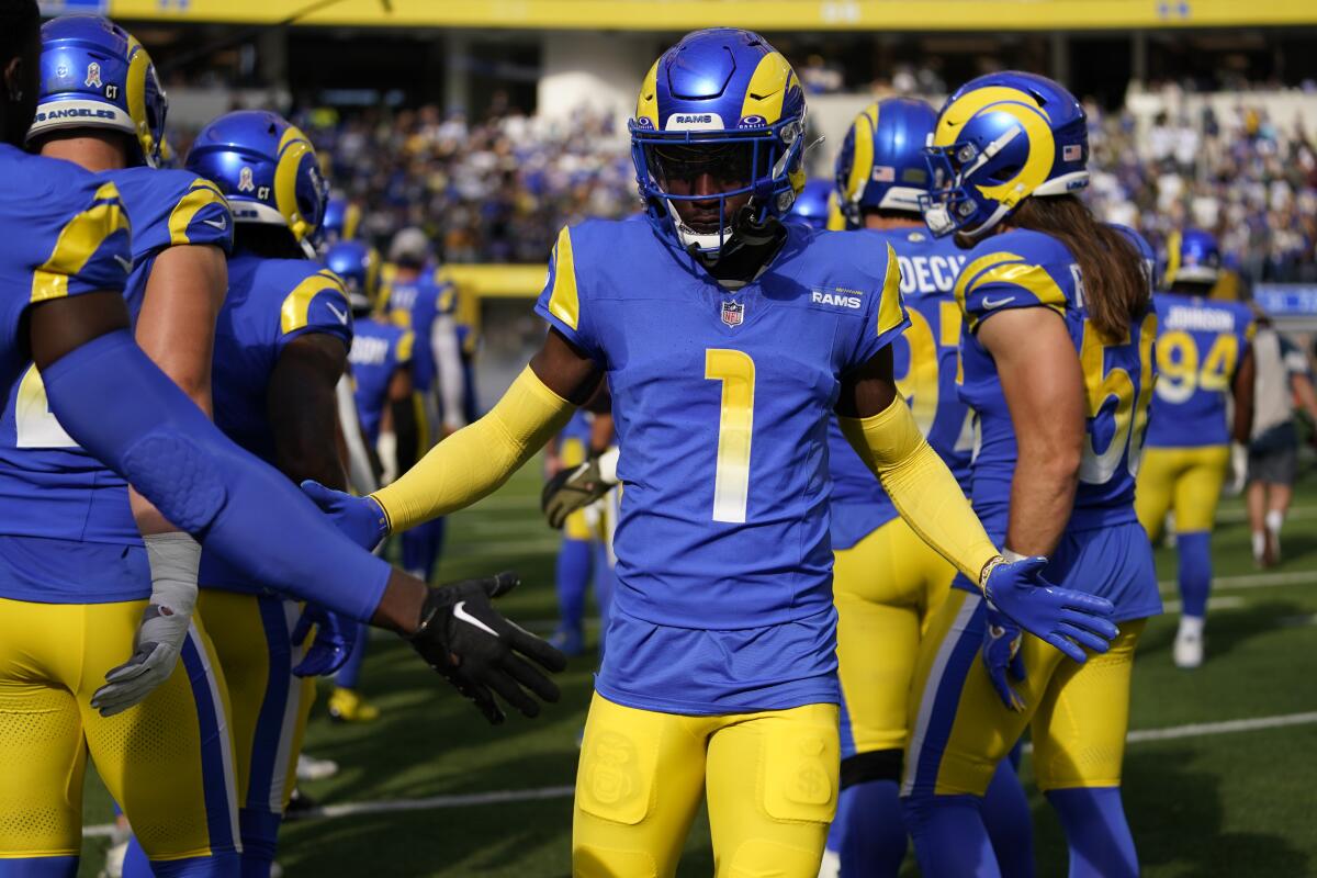 Rams cornerback Derion Kendrick (1) greets teammates as he is introduced before a game