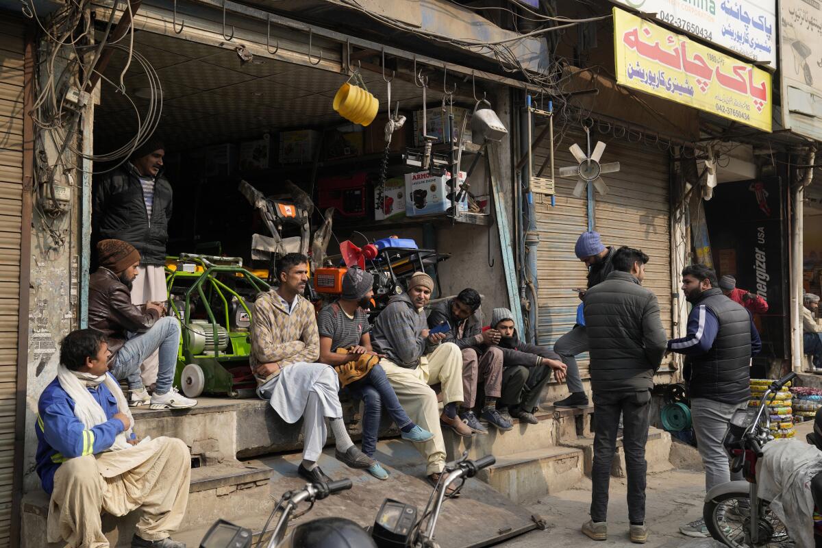 Shopkeepers and workers sitting around during power outage
