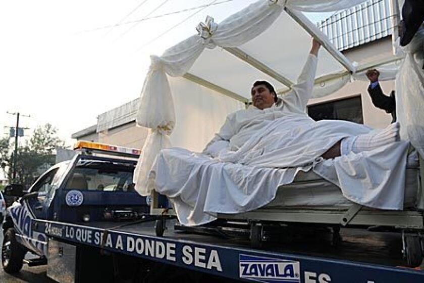 Manuel "Meme" Uribe, 43, is driven in a forklift to the dance hall where he and Claudia Solis will get married in Monterrey, Mexico, Sunday, Oct. 26, 2008. Uribe, who tipped the scales in 2006 at 1,230 pounds, earning him the Guinness Book of World Records' title for the world's heaviest man, lost 550 pounds (250 kilograms) with the help of Solis, whom he met four years ago.