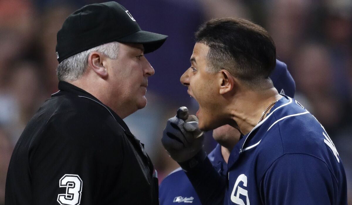 San Diego Padres' Manny Machado, right, yells at home plate umpire Bill Welke 