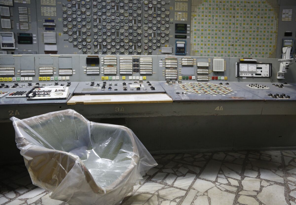 FILE - An operator's arm-chair covered with plastic sits in an empty control room of the 3rd reactor at the Chernobyl nuclear plant, in Chernobyl, Ukraine, on April 20, 2018. Russia’s attack on a nuclear power plant in Ukraine has revived the fears of people across Europe who remember the 1986 Chernobyl disaster. (AP Photo/Efrem Lukatsky, File)