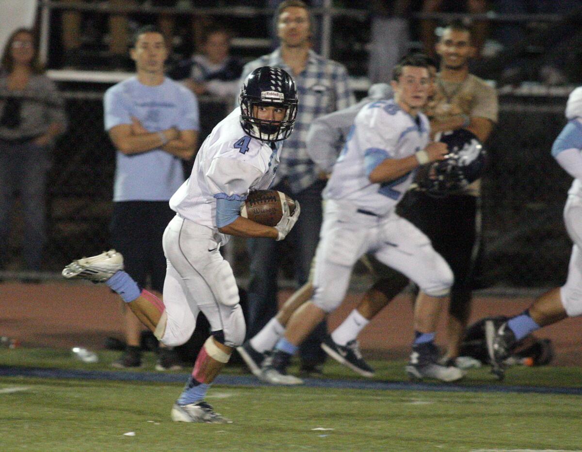 Crescenta Valley's Jordan Lobianco looks back over his shoulder after making a catch as he runs over 50 yards to score against Muir in the first half of a Pacific League football game at Muir High School on Friday, October 24, 2014.