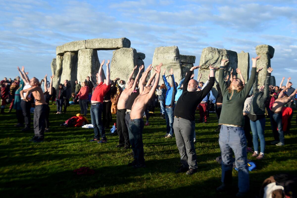 Visitors participate in yoga exercises. (Finnbarr Webster / Getty Images)