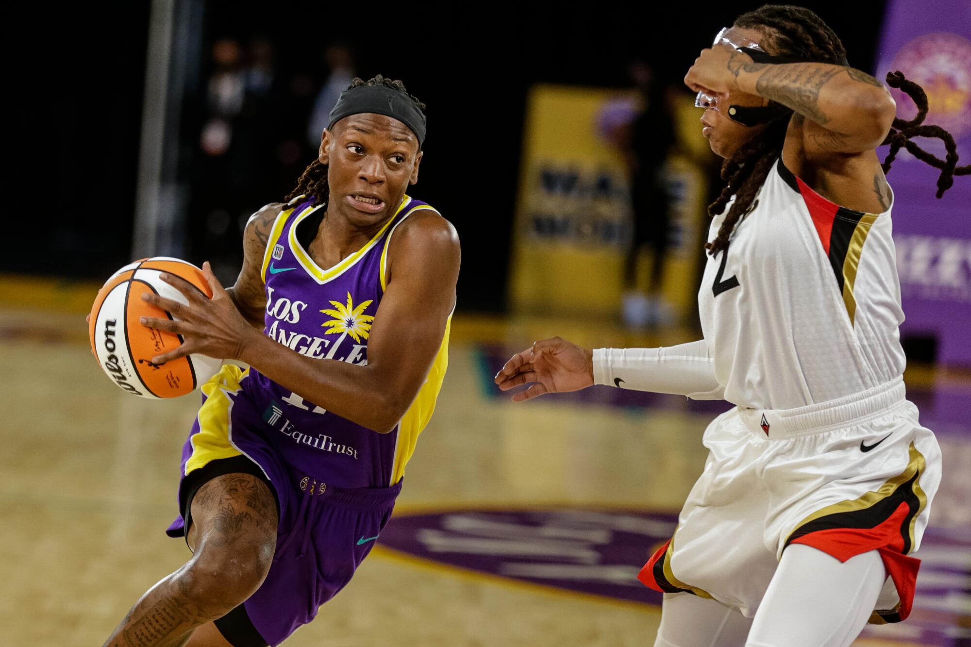 Sparks point guard Erica Wheeler handles the ball against a player for the Las Vegas Aces on June 30.