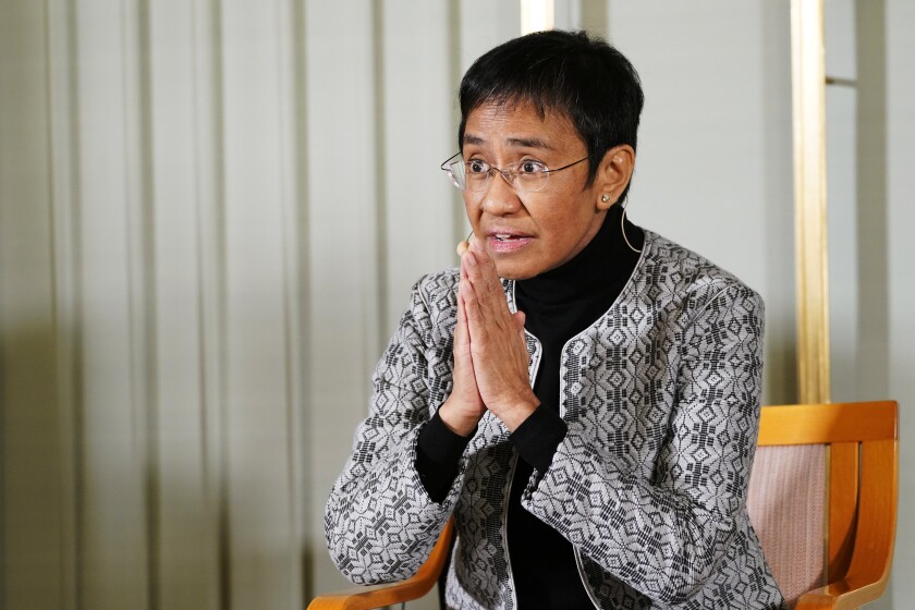 Filipino journalist Maria Ressa sits with fellow peace Prize winner Russian journalist Dmitry Muratov, during a press conference, at the Nobel Institute, a day prior to the award ceremony, in Oslo, Norway, Thursday, Dec. 9, 2021. (Torstein Boe/Pool Photo via AP)