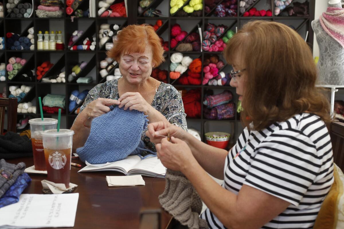 Westminster residents Teri Hendrix, left, and Jill Holt work on their garments at Knit Schtick in Costa Mesa on Tuesday. A group of women made 1920s-style cloche hats and gloves to wear to opening night for the "Downton Abbey" movie.