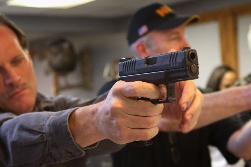 TINLEY PARK, IL - JANUARY 19: Students learn how to fire a pistol during an NRA Basic Pistol Course at Freddie Bear Sports sporting goods store on January 19, 2012 in Tinley Park, Illinois. Gun rights supporters have proclaimed today Gun Appreciation Day and encouraged gun owners to visit local gun shops, gun ranges and to rally at their state capitals. (Photo by Scott Olson/Getty Images) ORG XMIT: 159875301