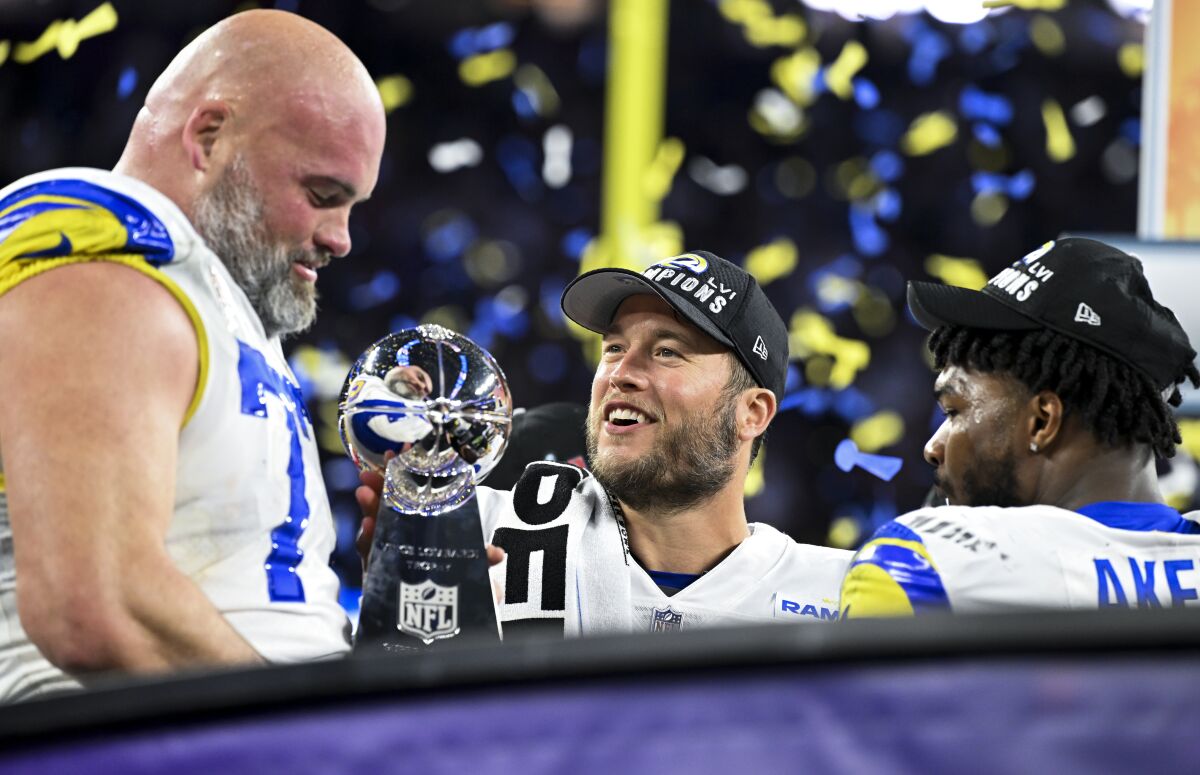 Rams quarterback Matthew Stafford celebrates Super Bowl win with teammates Andrew Whitworth and Cam Akers.