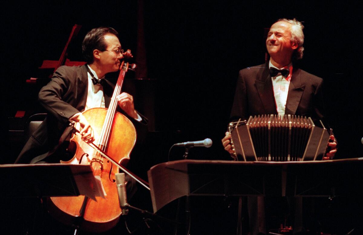 Yo–Yo Ma plays cello and Nestor Marconi plays bandoneón onstage.