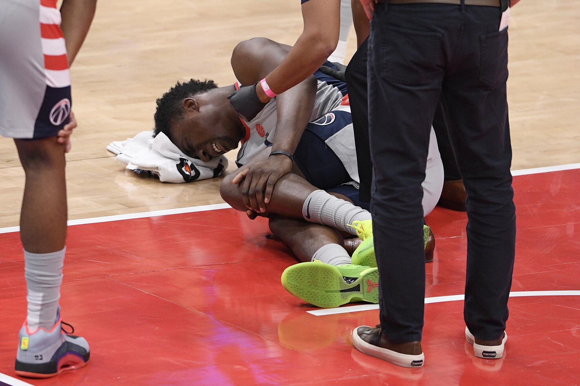 Thomas Bryant lies on the court after tearing an ACL playing for the Wizards on Jan. 9, 2021.