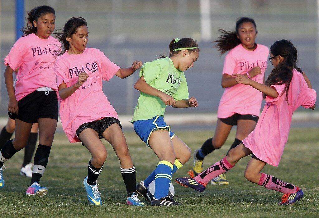 Newport Coast's Emily Mickelsen, center, competes against four Whittier players during a Pilot Cup girls' 5-6 silver division game on Thursday.