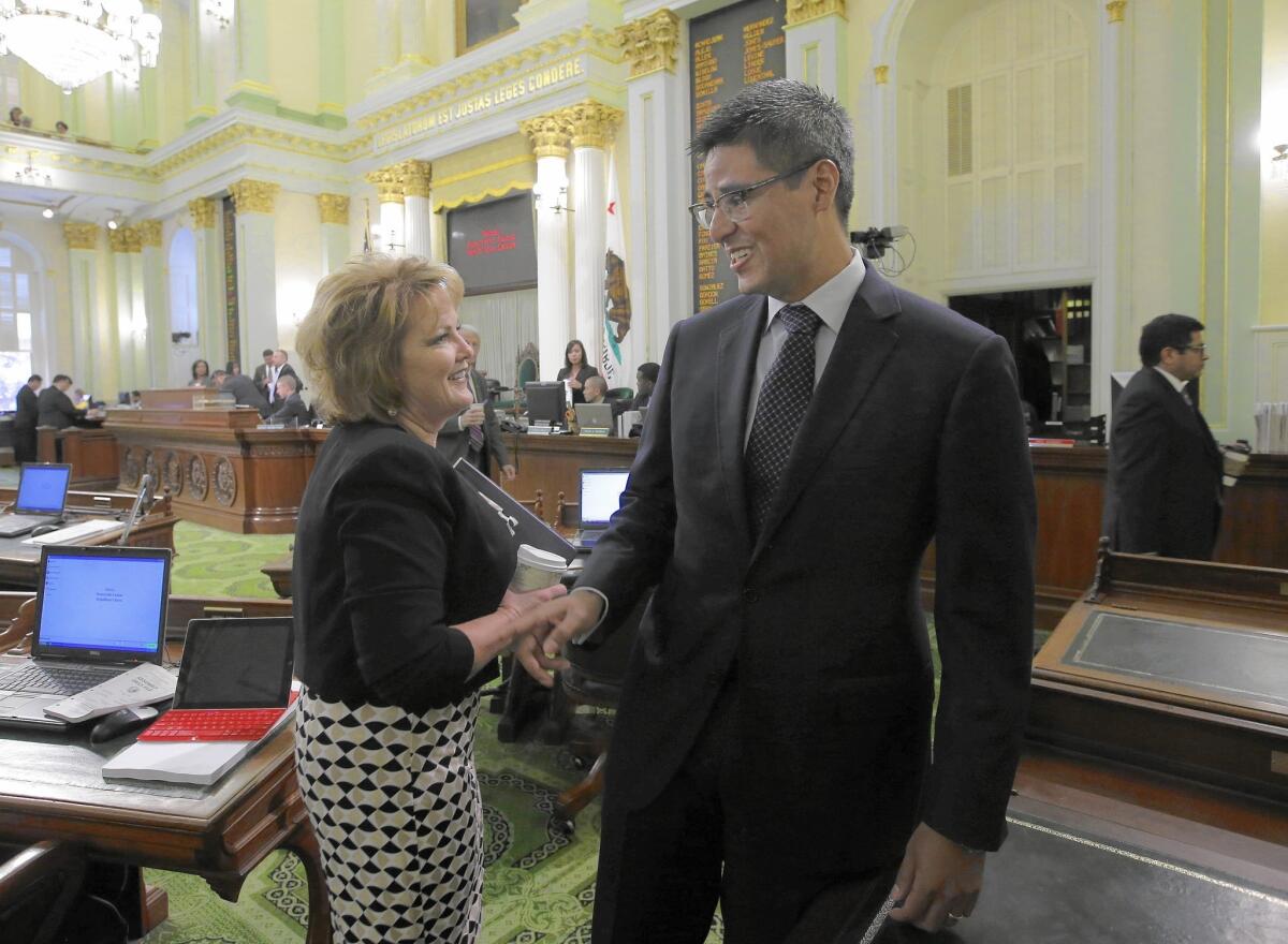 Assemblywoman Shannon Grove (R-Bakersfield) talks during the summer with Assemblyman Henry T. Perea (D-Fresno), who leads the moderate Democrats.
