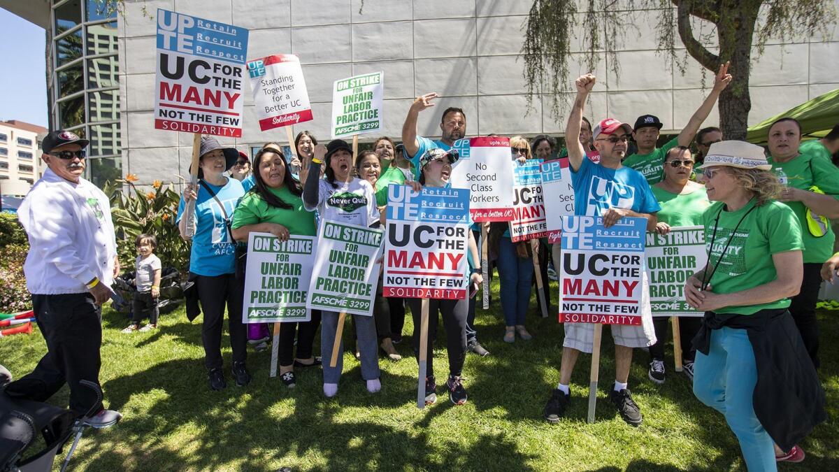 University of California workers walk the picket line at UC Irvine Medical Center in Orange during a one-day strike Wednesday.