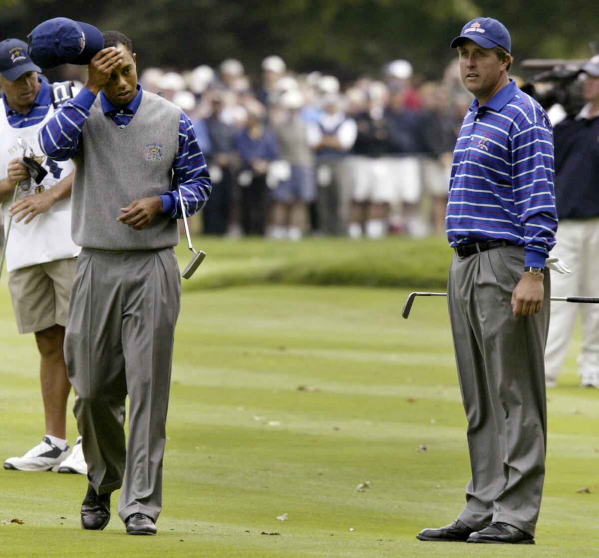 Tiger Woods and Phil Mickelson play in the Ryder Cup competition at Michigan's Oakland Hills Country Club on Sept. 17, 2004.