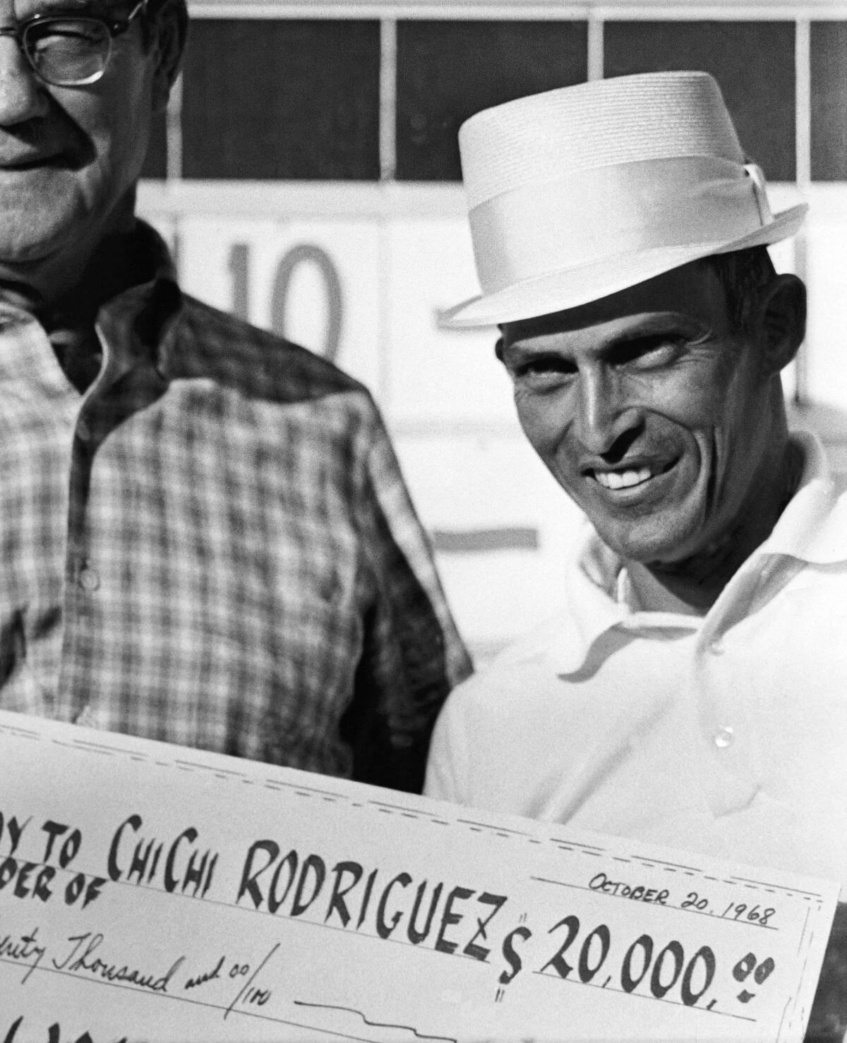 Chi Chi Rodriguez accepts the $20,000 check from Dell E. Webb after winning the Sahara Invitational in Las Vegas in 1968