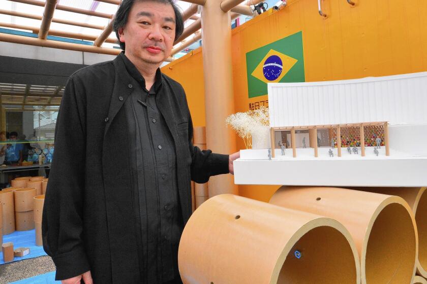 Japan's 2014 Pritzker Architecture Prize winner Shigeru Ban displays a scale model of his designed pavilion built in the grounds of the Brazilian embassy in Tokyo for the FIFA World Cup in Brazil on June 10, 2014.