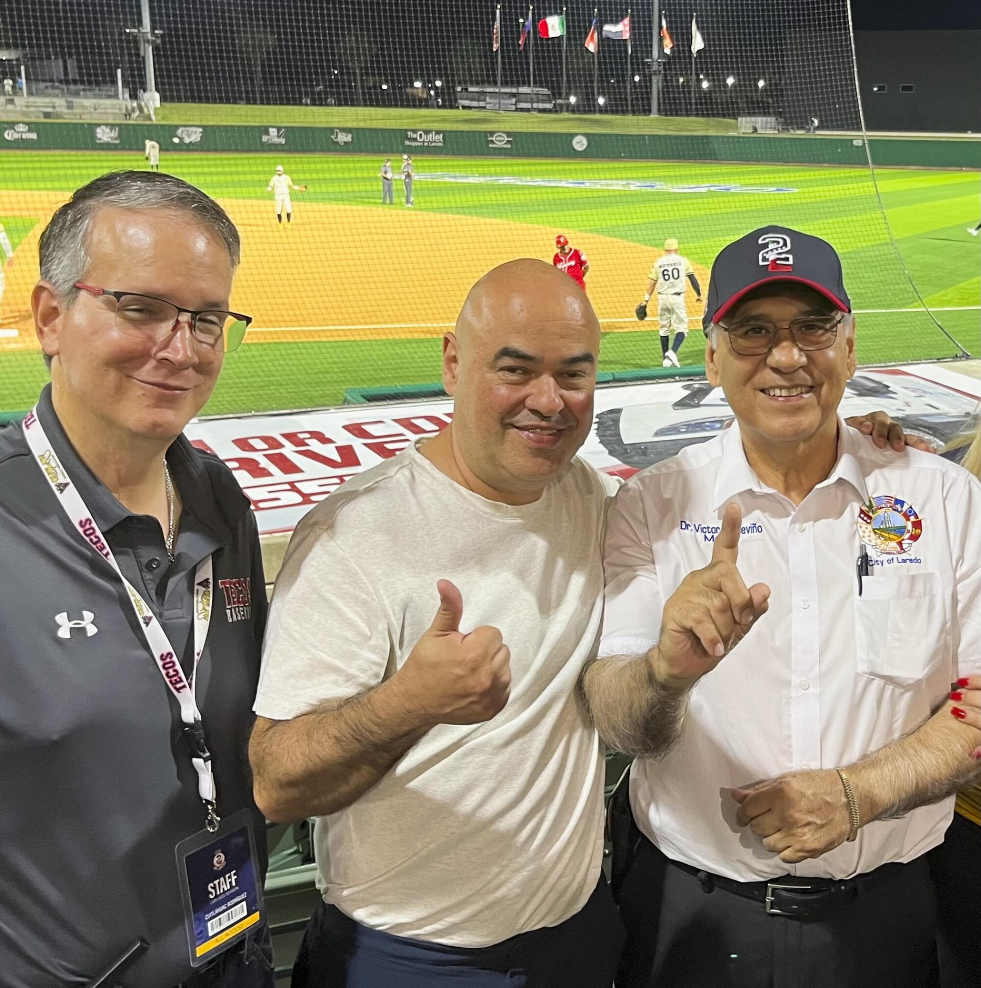 Tecos manager Cuitlahuac Rodriguez, team president Chara Mansur and Laredo Mayor Victor Treviño pose for a photo.