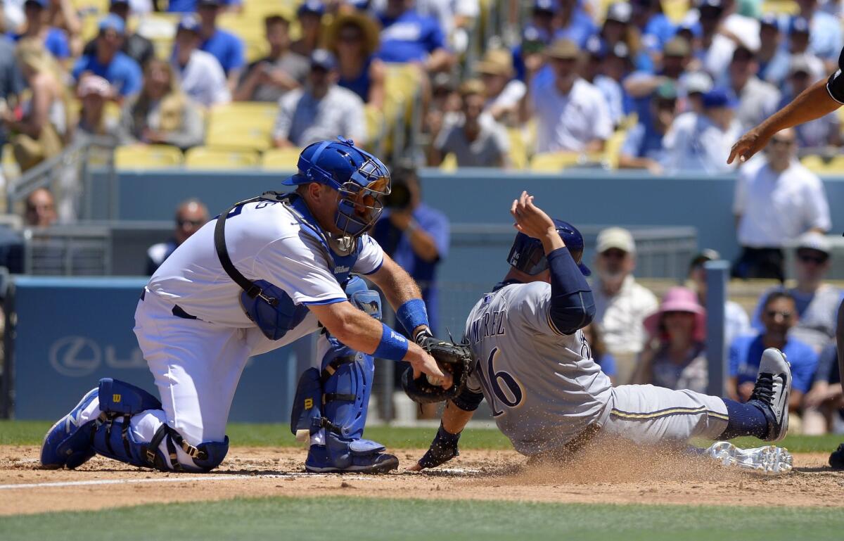 Dodgers catcher A.J. Ellis tags out Milwaukee's Aramis Ramirez on July 12.