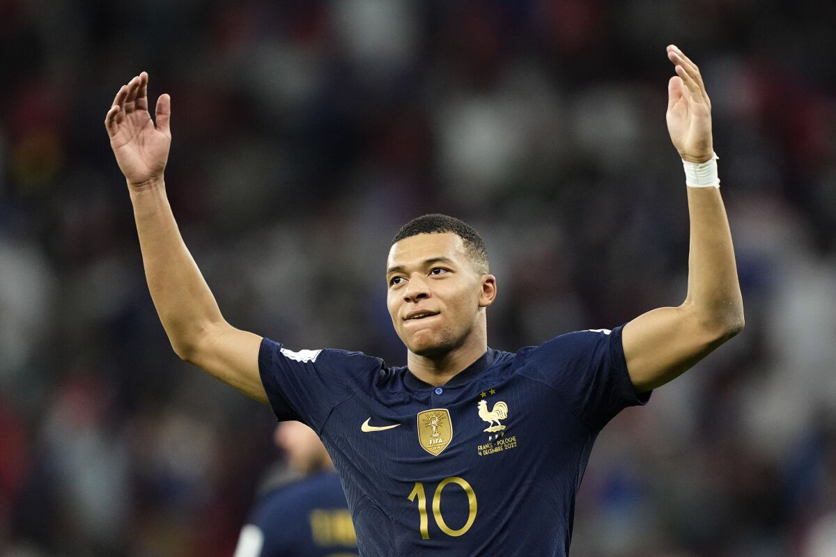 France's Kylian Mbappe celebrates scoring his side's third goal during the World Cup round of 16 soccer match between France and Poland, at the Al Thumama Stadium in Doha, Qatar, Sunday, Dec. 4, 2022. (AP Photo/Martin Meissner)