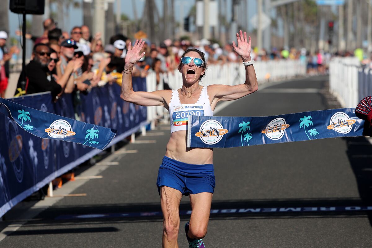 Michelle Jacobsen, 43, of Newport Beach is the first woman full marathon runner to cross the finish line.