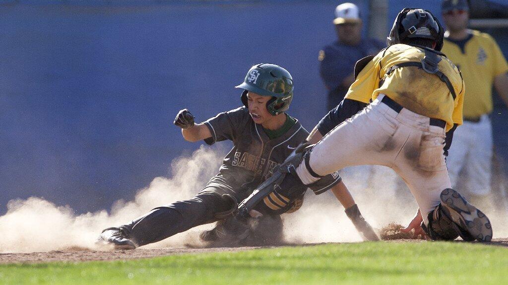 Sage Hill School's Matt King beats the throw to home plate during the seventh inning against Crean Lutheran in the CIF-SS Division 6 baseball championship game at UCR Sports Complex in Riverside on Saturday.