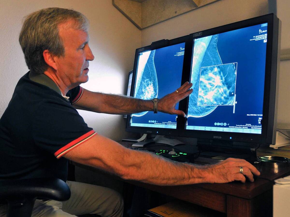 Radiologist Paul Bice compares a 2-D mammogram with a 3-D version, which offers more detail.