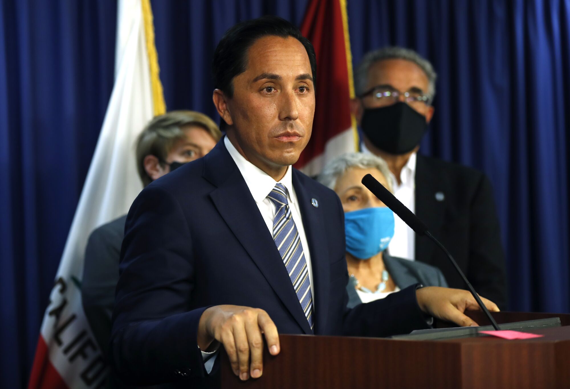 San Diego Mayor Todd Gloria, surrounded by city council members, at a news conference on Monday, Nov. 29, 2021.