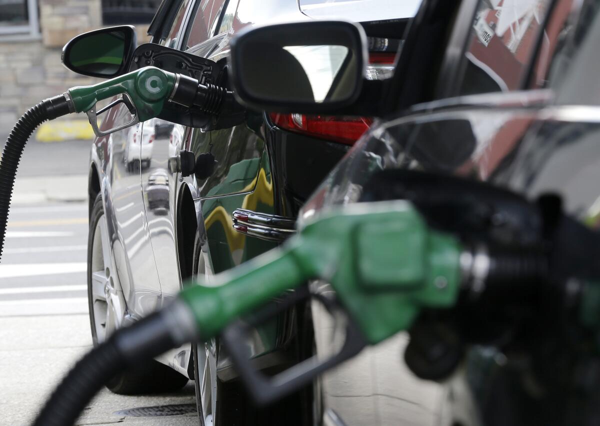 Gas is pumped into vehicles at a BP gas station in Hoboken, N.J., in June.