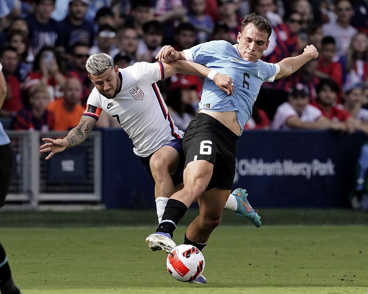 U.S. forward Paul Arriola, left, and Uruguay midfielder Manuel Ugarte battle for the ball. 
