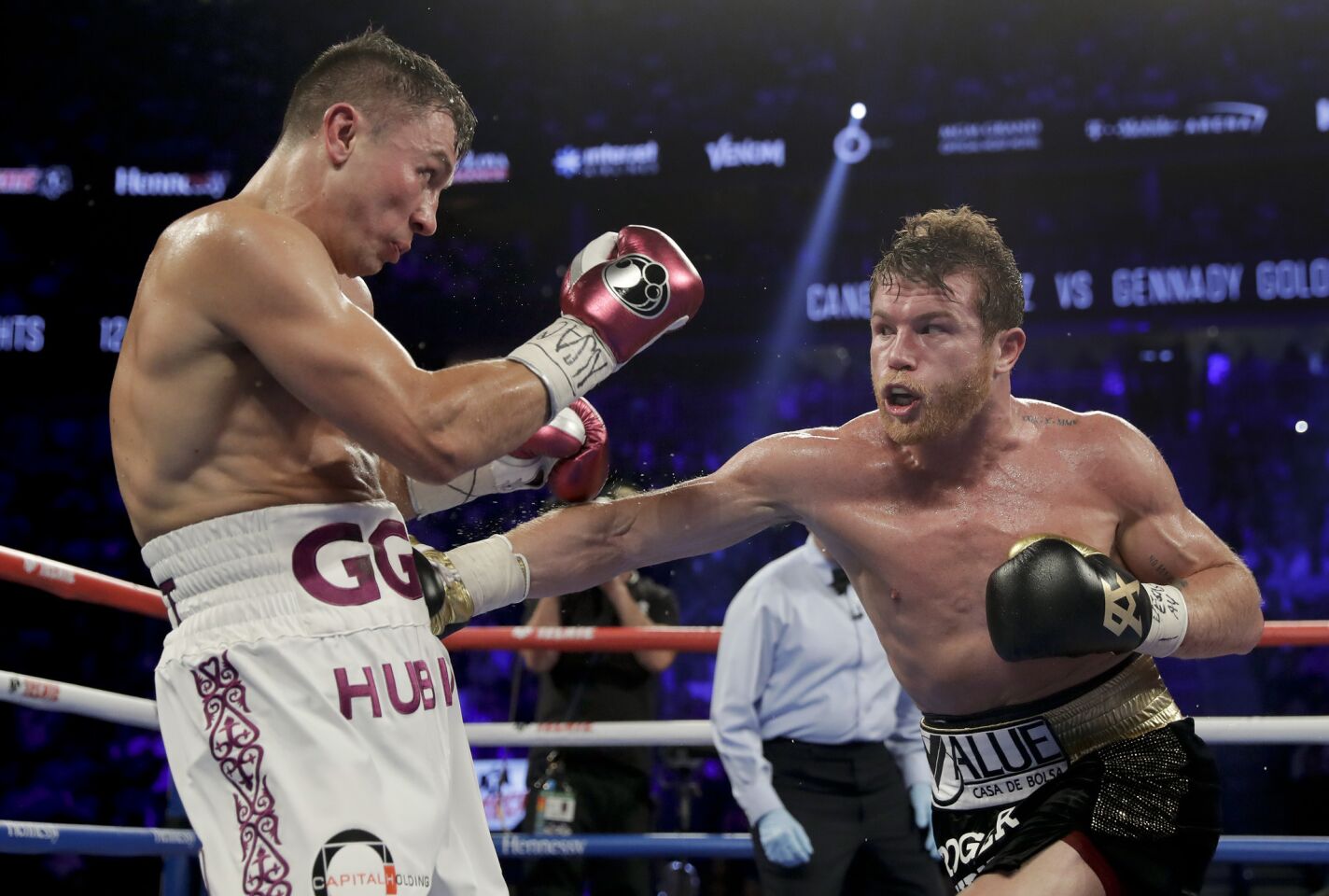 Canelo Alvarez, right, and Gennady Golovkin trade punches in the fourth round during a middleweight title boxing match, Saturday, Sept. 15, 2018, in Las Vegas.