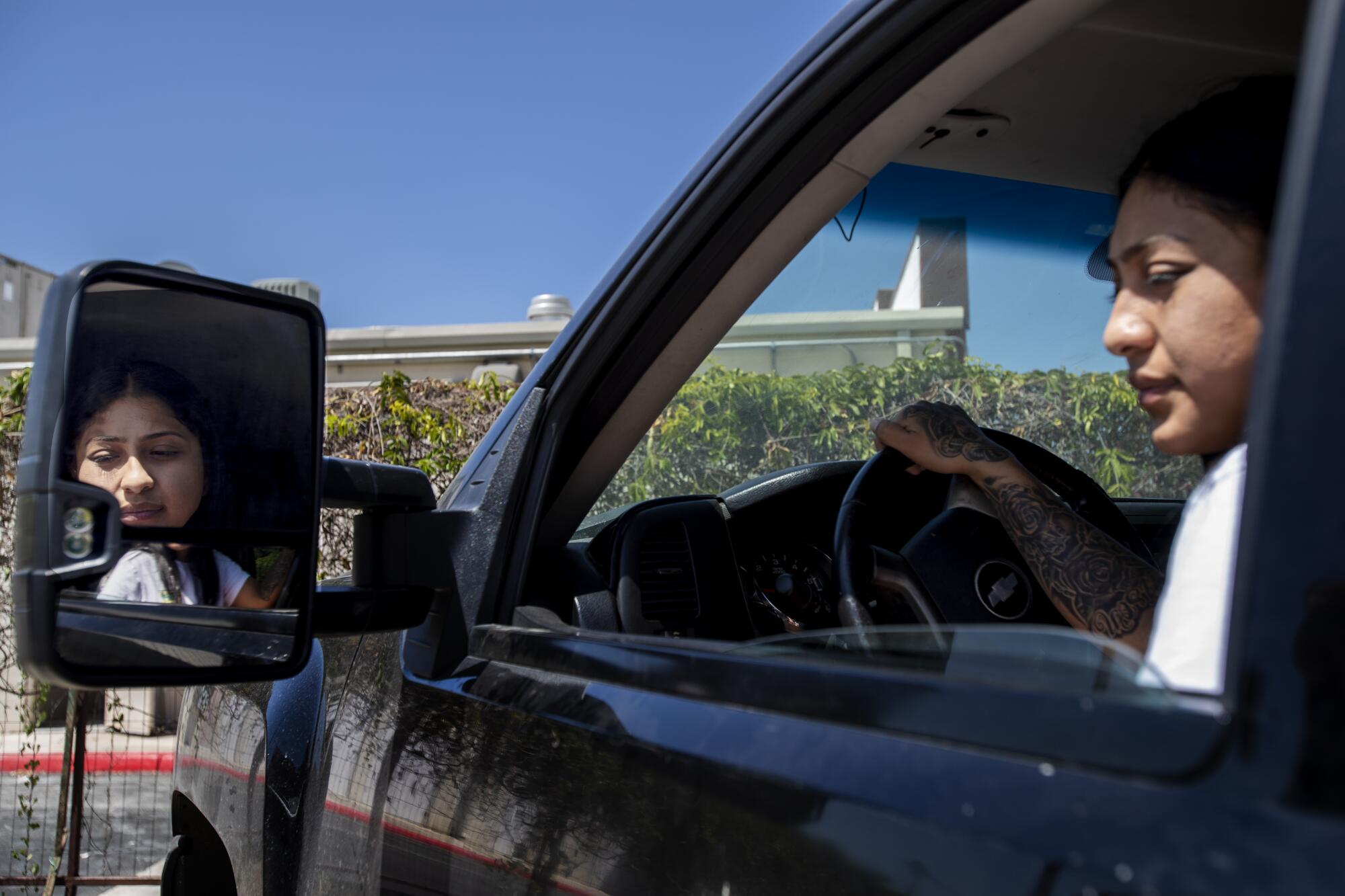 Woman looks out her car window