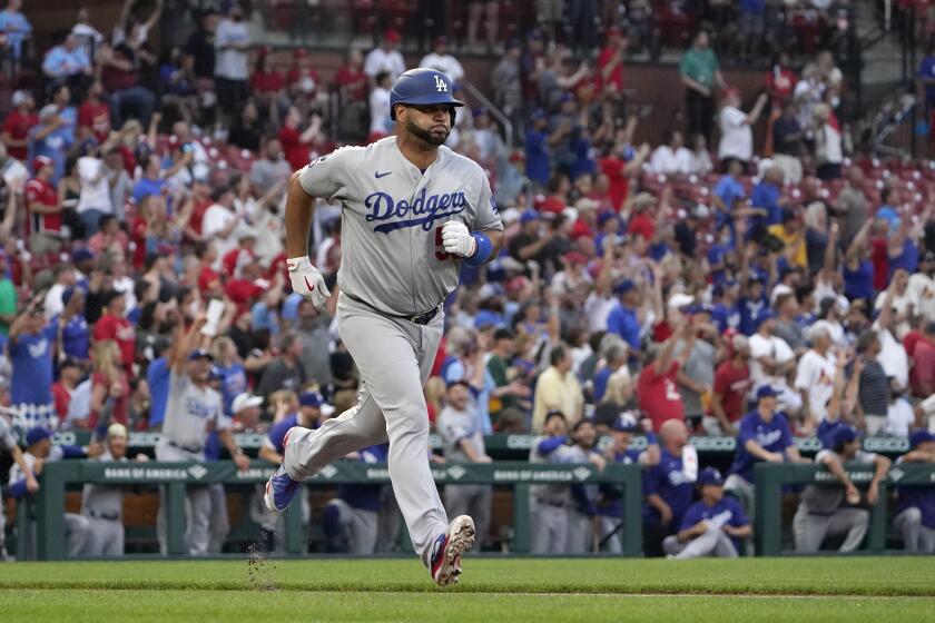 Los Angeles Dodgers' Albert Pujols rounds the bases after hitting a solo home run during the first inning of a baseball game against the St. Louis Cardinals Tuesday, Sept. 7, 2021, in St. Louis. (AP Photo/Jeff Roberson)