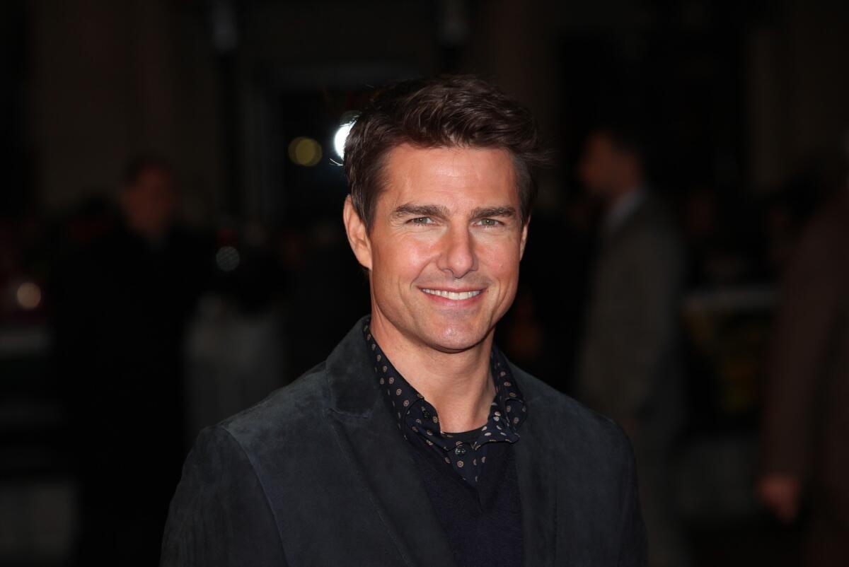 The publisher of Life & Style and InTouch magazines announced Friday that it had reached a confidential settlement with Tom Cruise over a pair of stories that implied the he had abandoned his daughter
