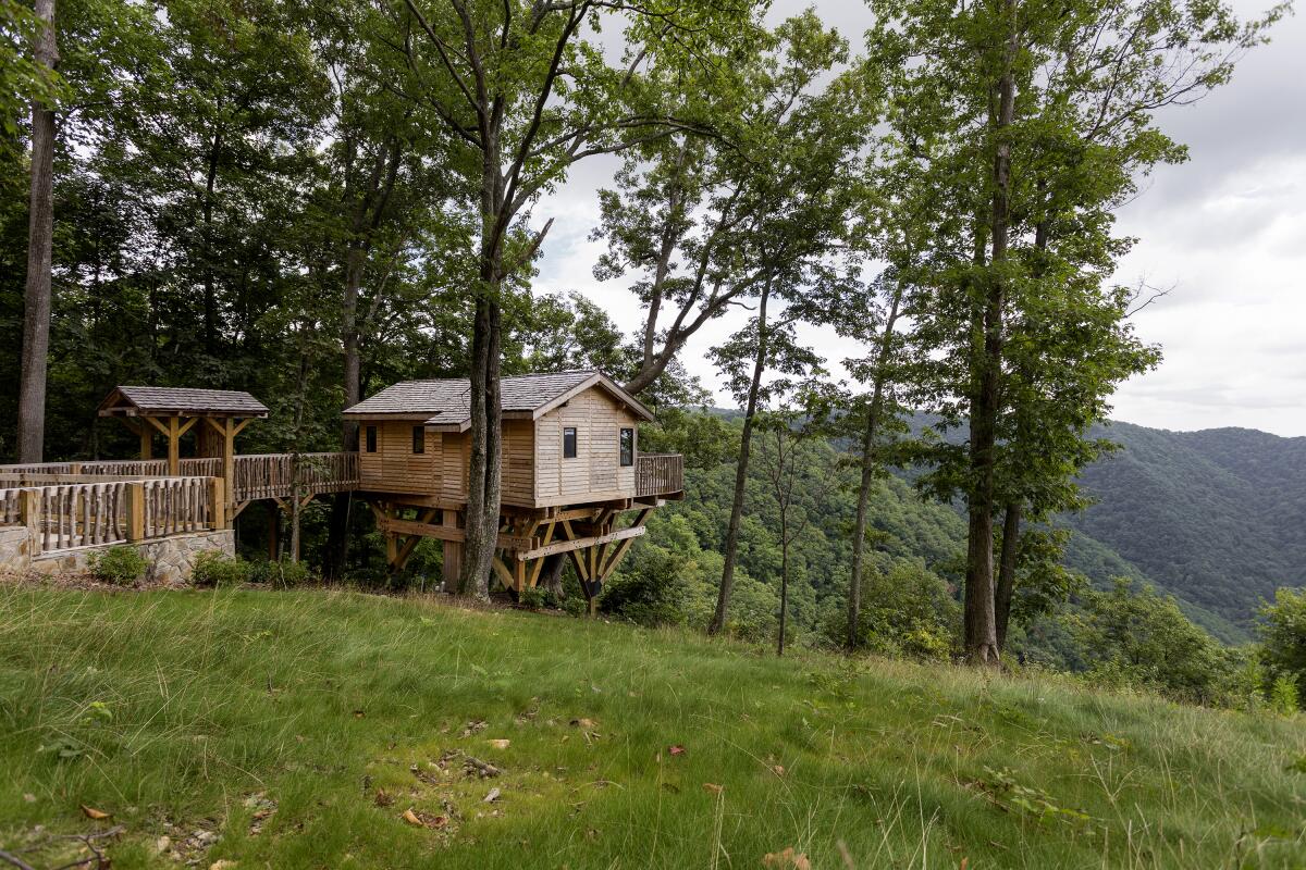 The adjacent sloping landscape at the Golden Eagle treehouse is ideal for a suspended bridge, used to carry in supplies.