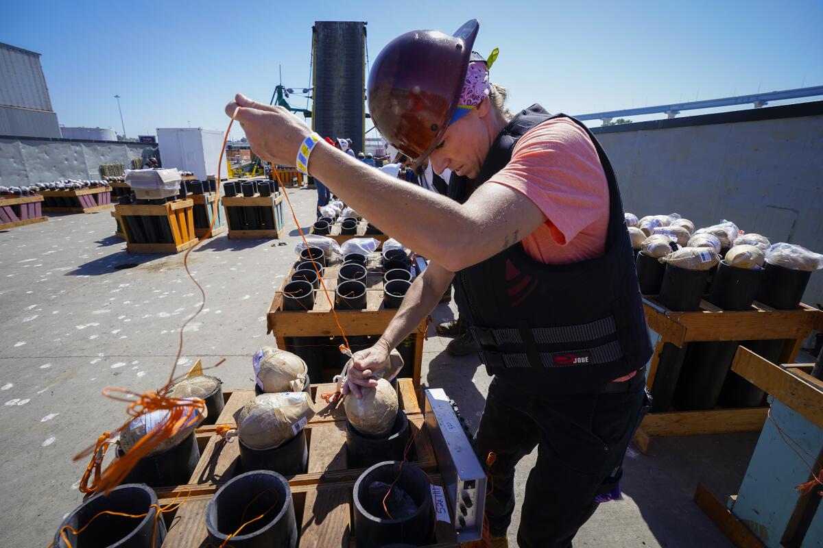 Jennifer Baldwin was among the crew loading mortar tubes with fireworks at 10th Avenue Marine Terminal.