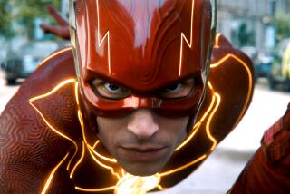 Ezra Miller leaning toward a camera in the red costume of "The Flash"