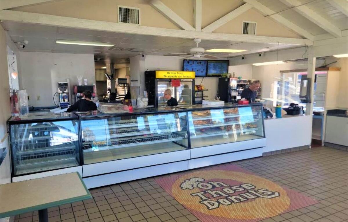 Employees of Oh Those Donuts and Deli clean up the store on Nov. 14, the business' last day after nearly 40 years of service.