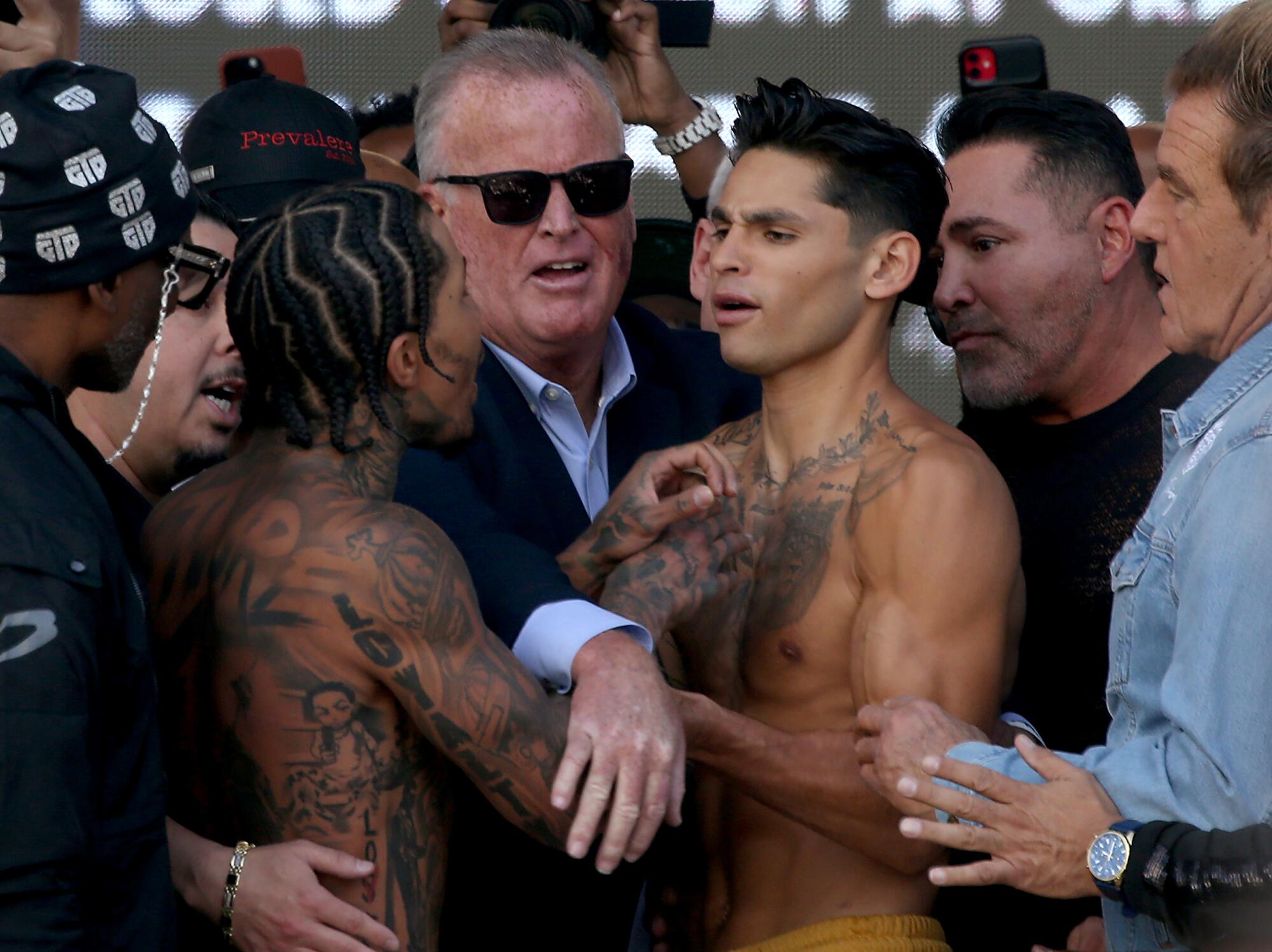 Things get a little physical between boxers Gervonta Davis, left, and Ryan Garcia as they face off during thre weigh-in.