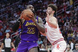 Los Angeles Lakers forward LeBron James (23) drives to the basket under pressure from Houston Rockets center Alperen Sengun during the first half of an NBA basketball game Wednesday, Nov. 8, 2023, in Houston. (AP Photo/Michael Wyke)