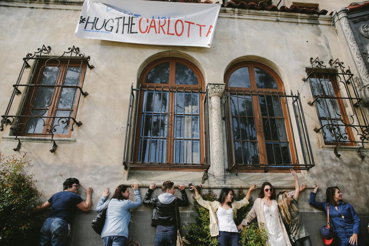 Residents and their supporters gather outside the Villa Carlotta apartment building on Franklin Avenue in Hollywood last month in an effort to stop evictions from the complex after the new owners expressed interest in converting the building into a hotel.