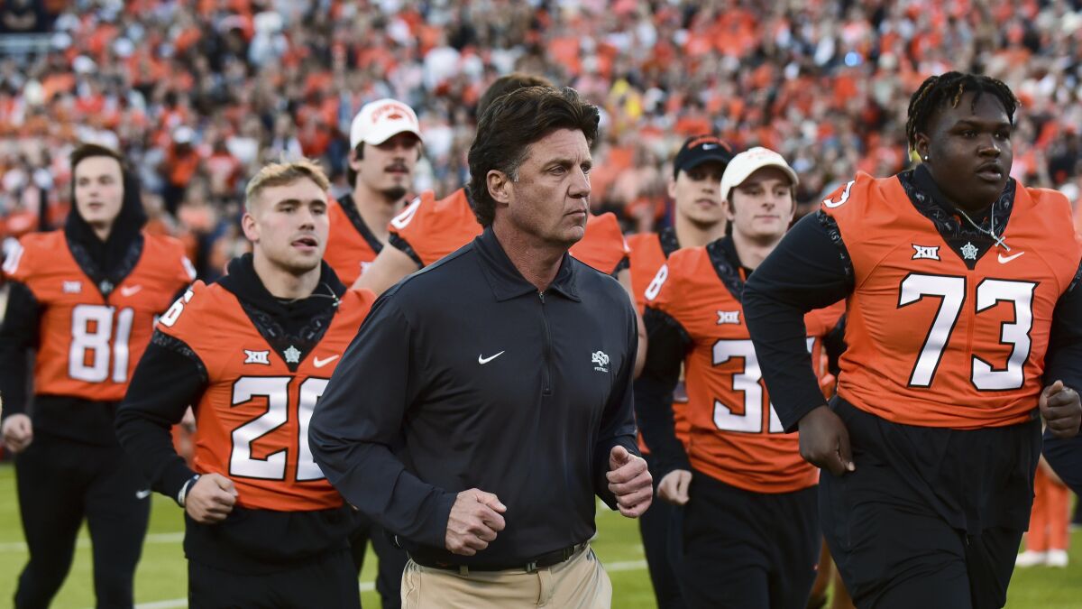 FILE - Oklahoma State coach Mike Gundy takes the field for the team's NCAA college football game against Kansas on Saturday, Oct. 30, 2021, in Stillwater, Okla. Oklahoma State plays against Texas Tech on Saturday, Nov. 20. (AP Photo/Brody Schmidt, File)