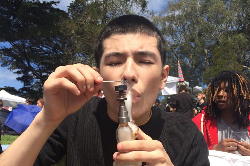 Sebastian Rosales smokes in Golden Gate Park in San Francisco on April 20 for the annual 4/20 celebration.