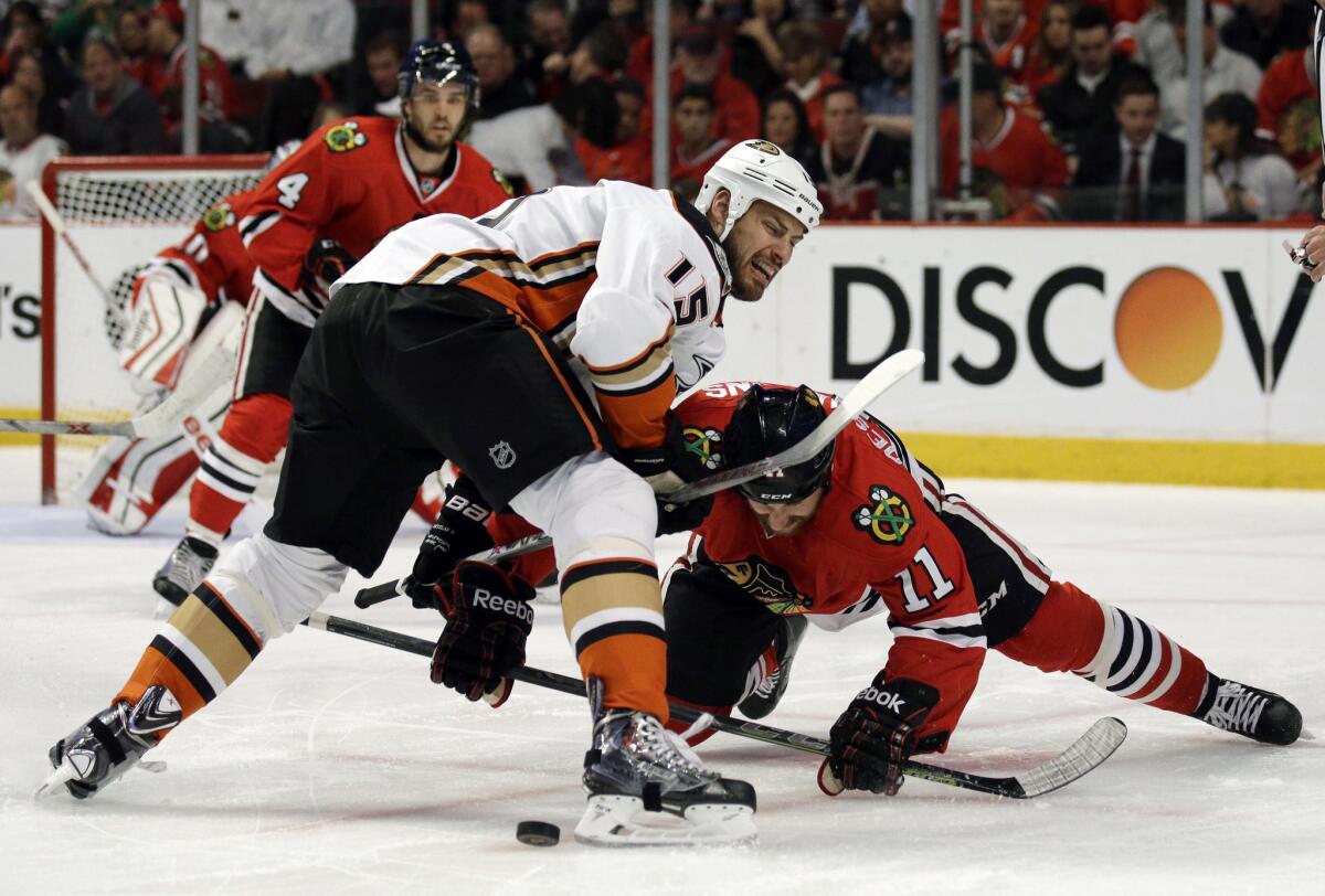 Ducks forward Ryan Getzlaf and Chicago forward Andrew Desjardins battle for the puck during the first period of Game 3 of the Western Conference finals.